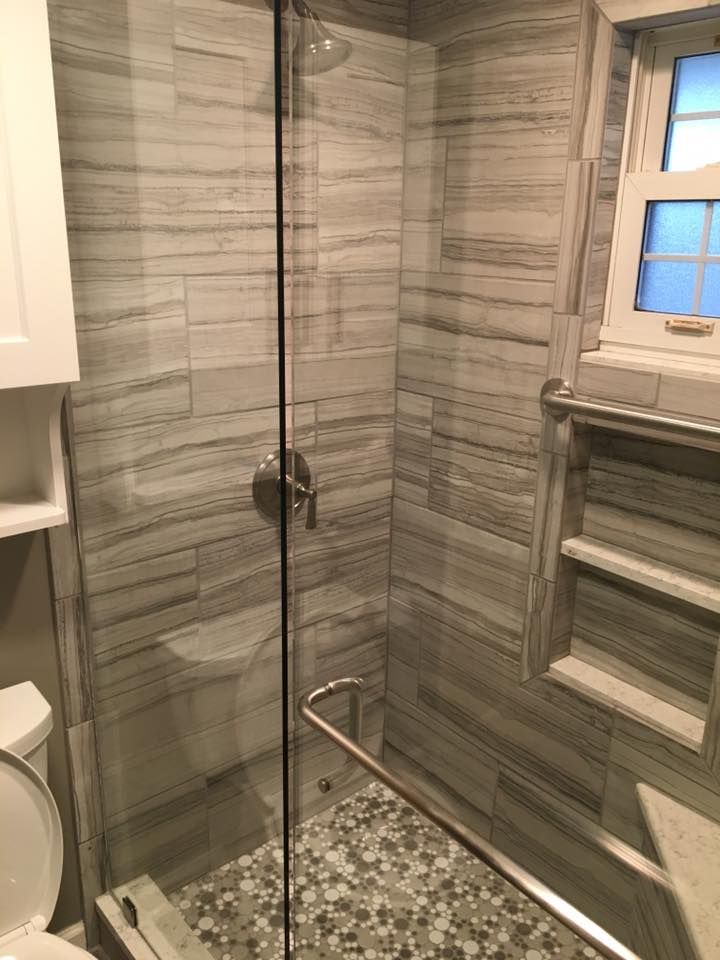 A bathroom with a walk in shower and a toilet.