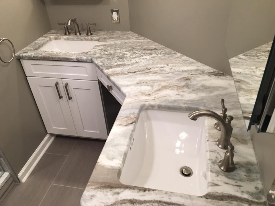 A bathroom with two sinks and a mirror