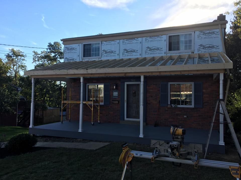 A brick house with a porch under construction