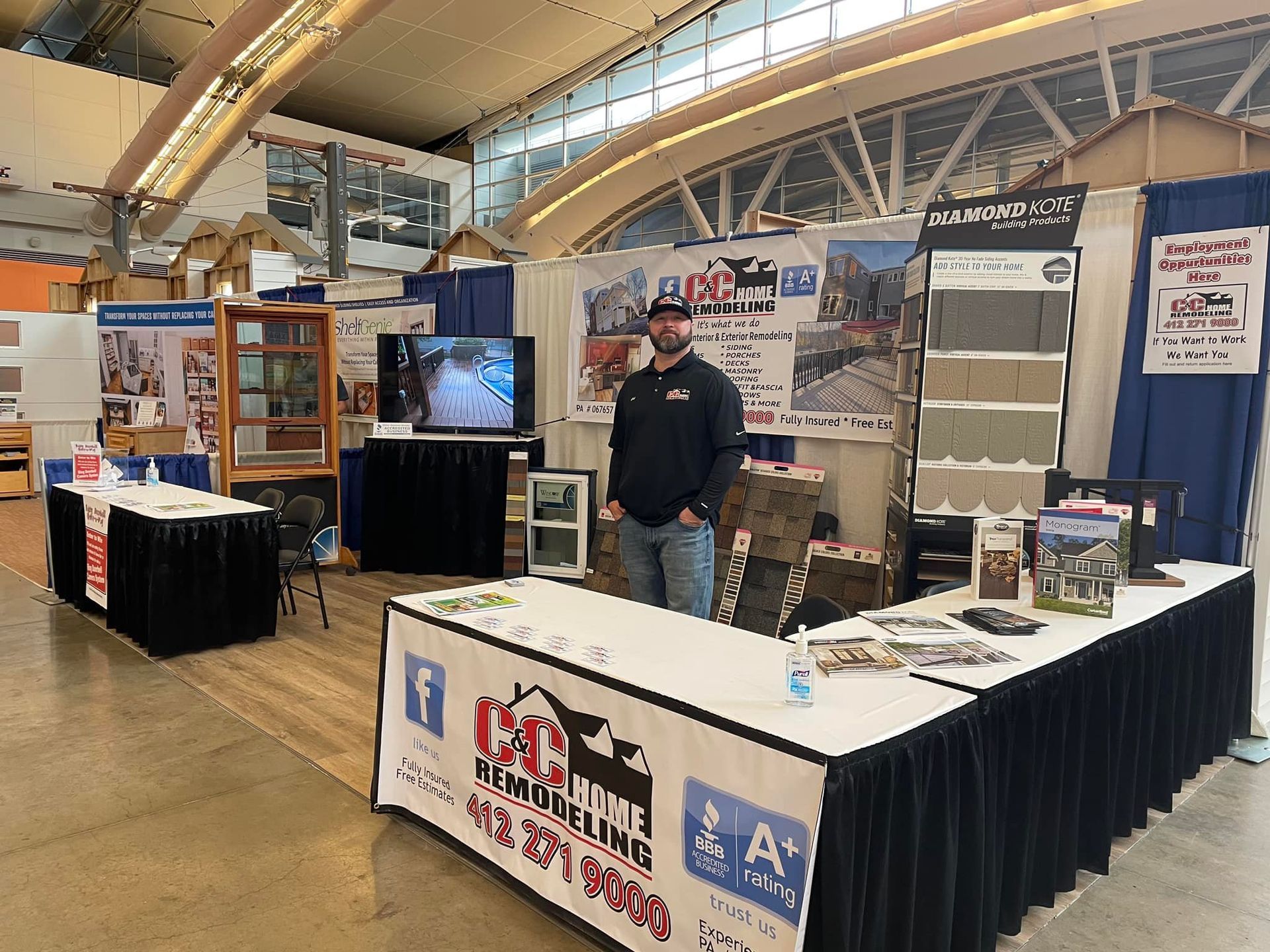 A man is standing in front of a table with a sign that says ' a ' on it.