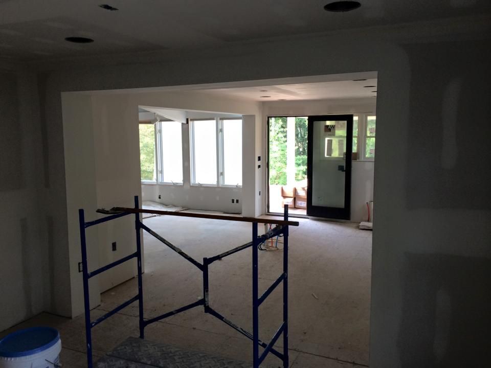 An empty room with a blue scaffolding in the middle