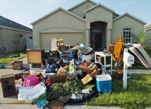 A house with a lot of junk in front of it