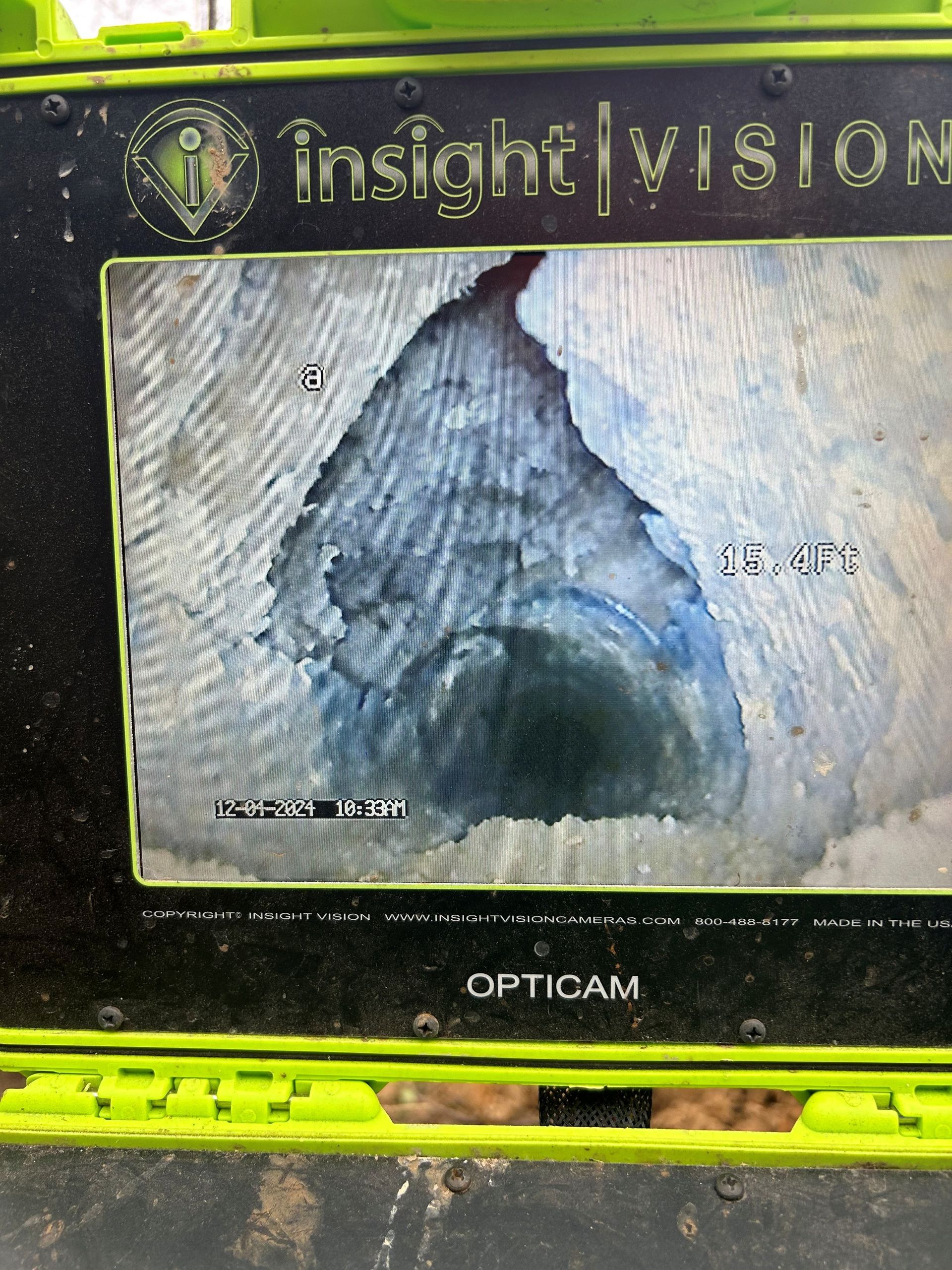 A computer screen shows a picture of a hole in a pipe.