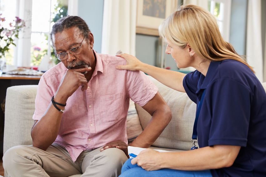 Support worker visits a senior man