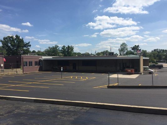 A large building with a parking lot in front of it