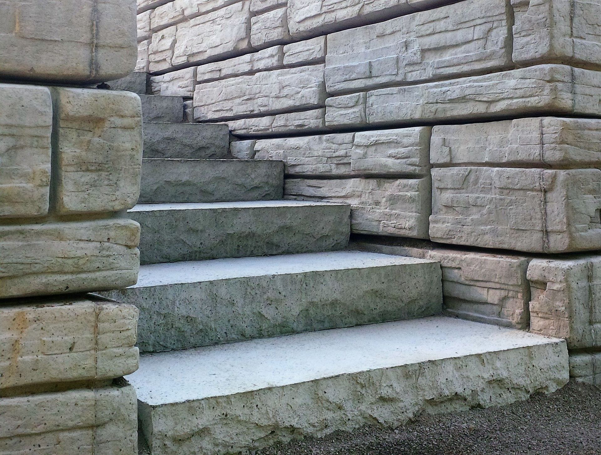 A set of stairs leading up to a stone wall