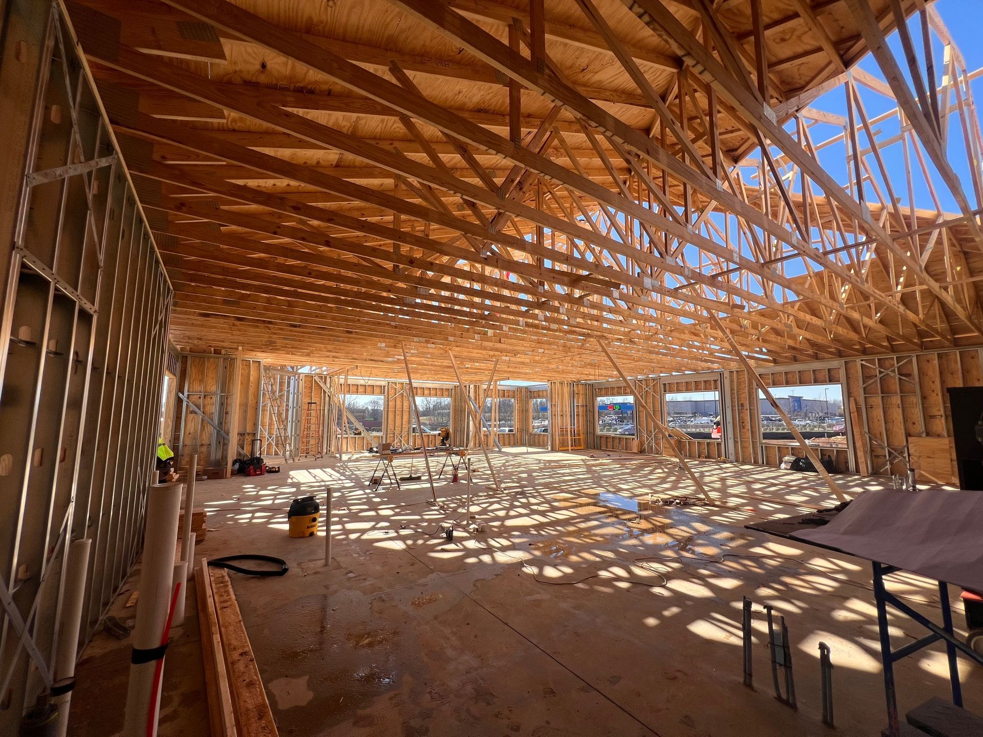 A large room under construction with a lot of wooden beams.
