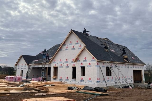 A house is being built and the roof is being installed.