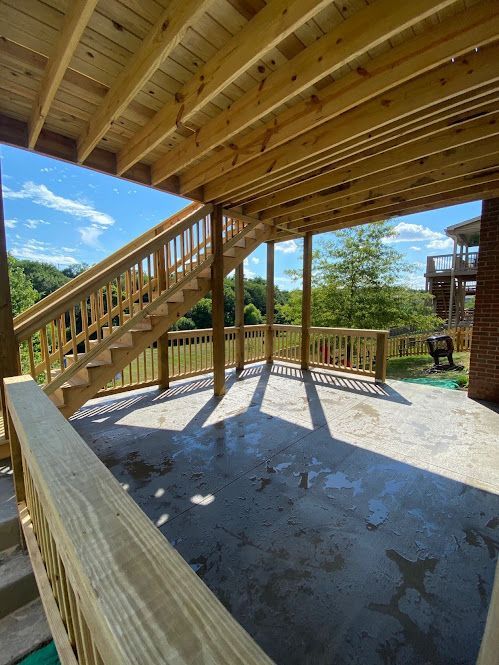 A wooden deck with stairs leading up to it.