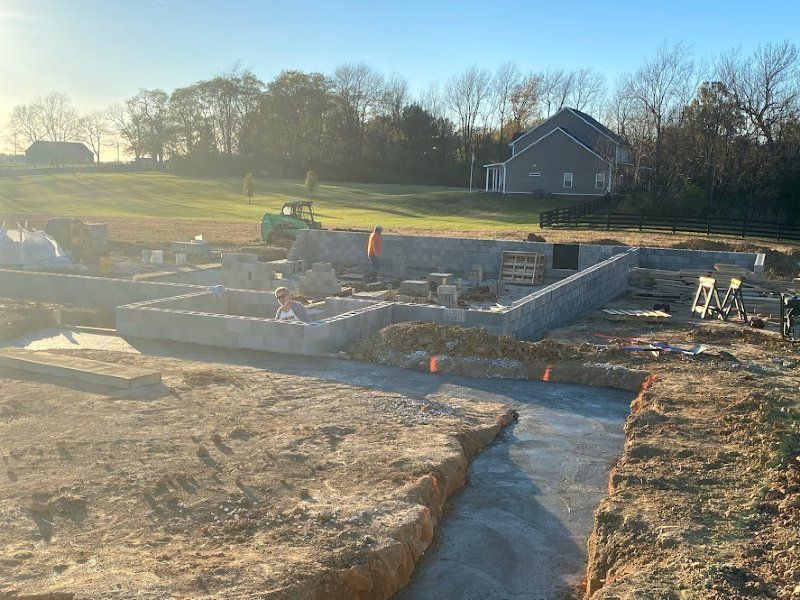 A house is being built in the middle of a field.