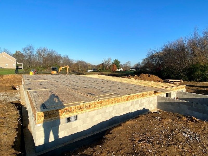 The foundation of a house is being built on a sunny day.