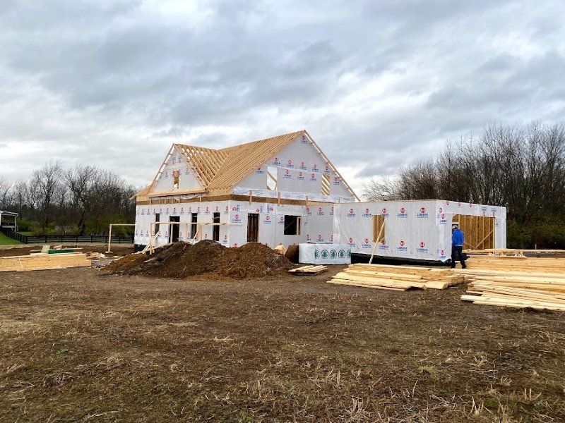 A large house is being built in a field.