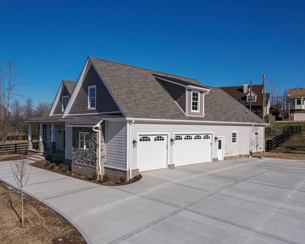An aerial view of a house with a garage and a driveway.