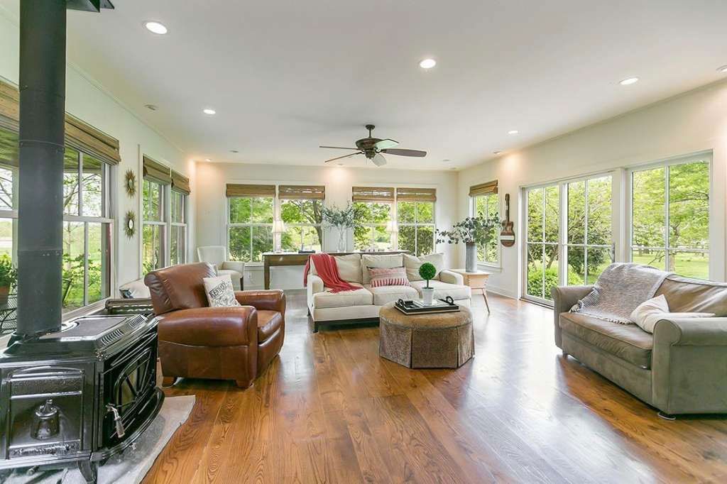 A living room filled with furniture and a wood stove