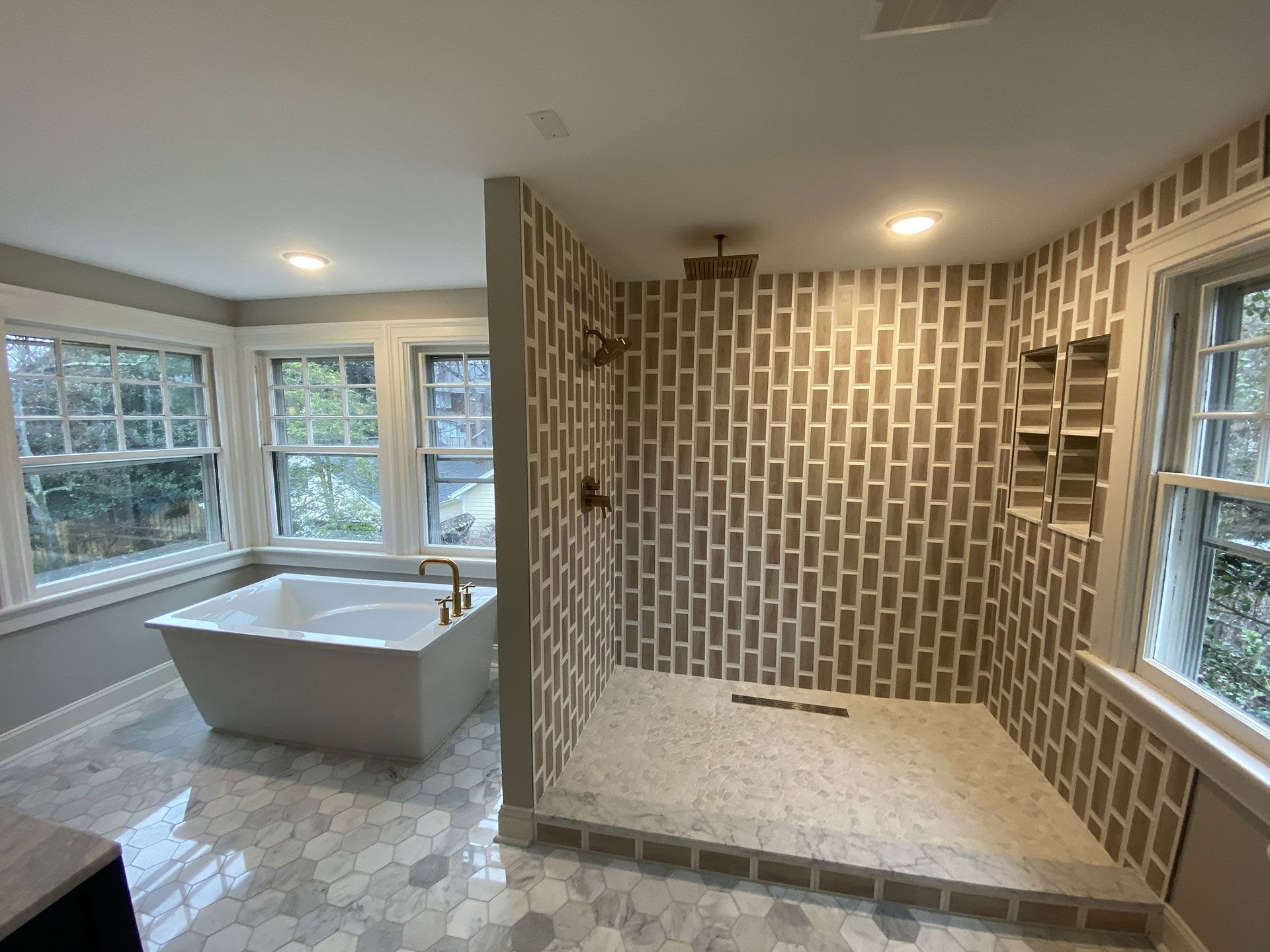 A bathroom with a tub and a walk in shower