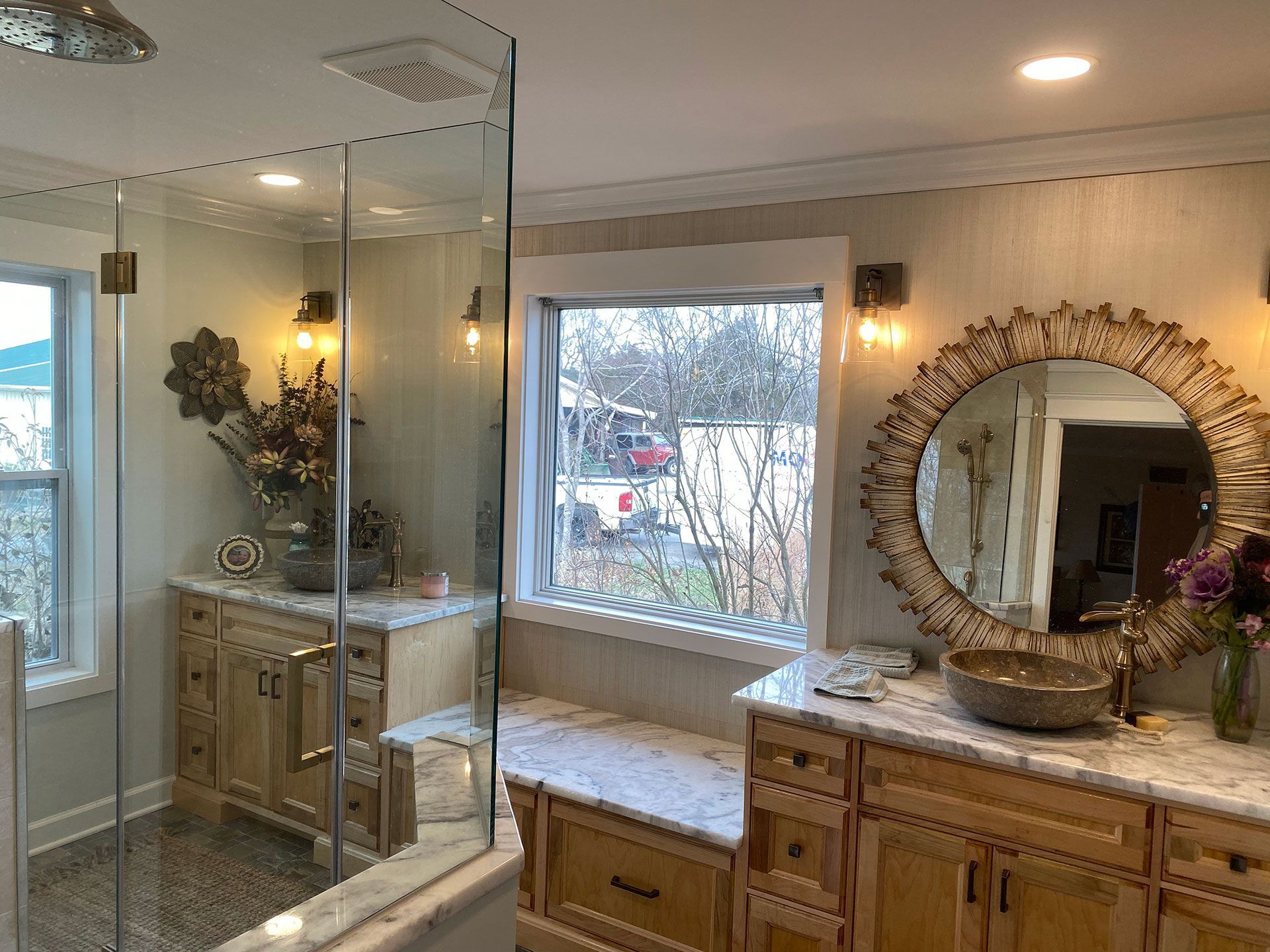 A bathroom with a sink, mirror and shower