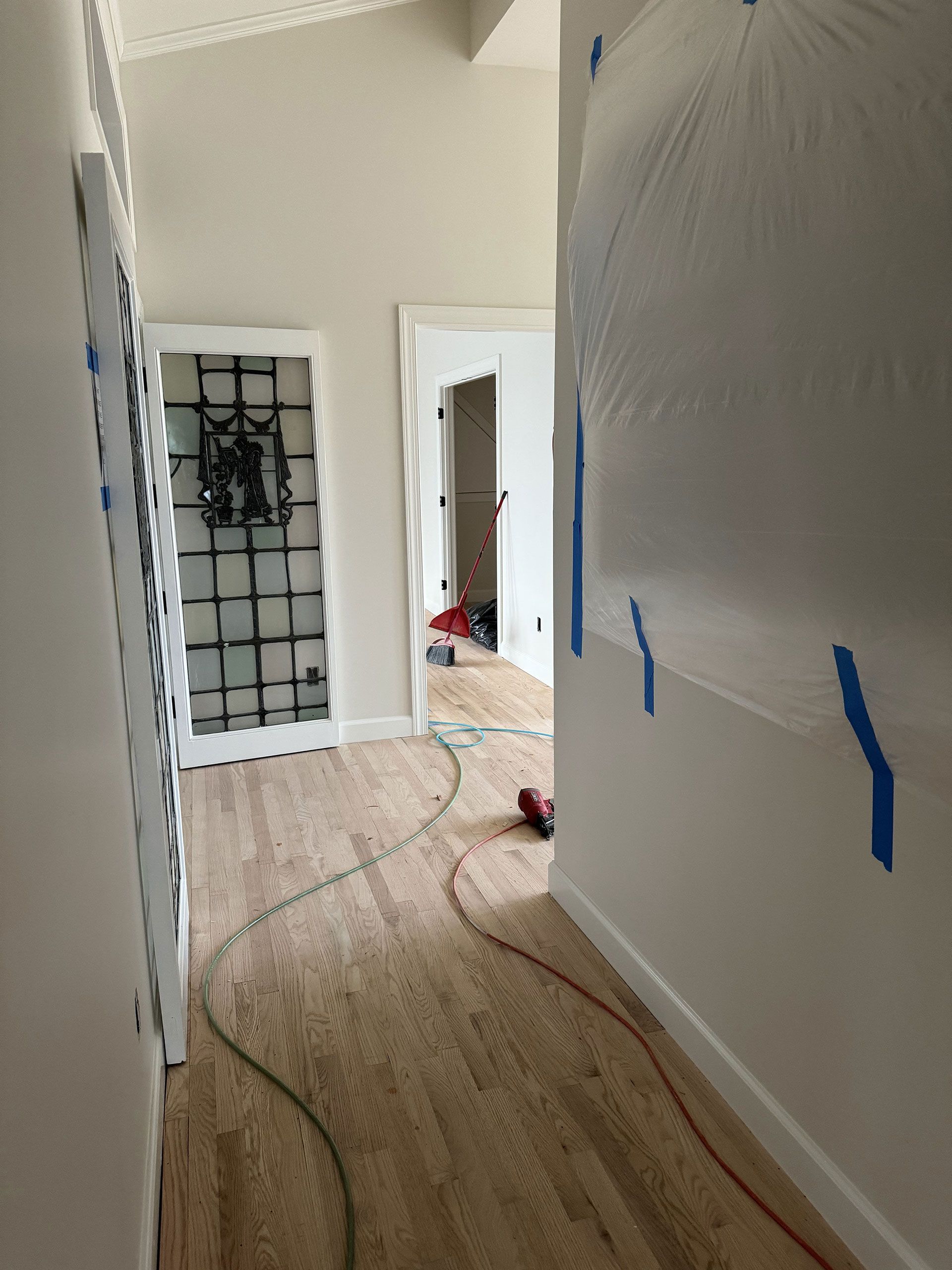 A hallway in a house that is being painted