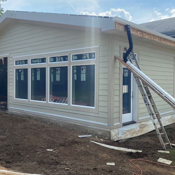 A ladder is leaning against the side of a house under construction.