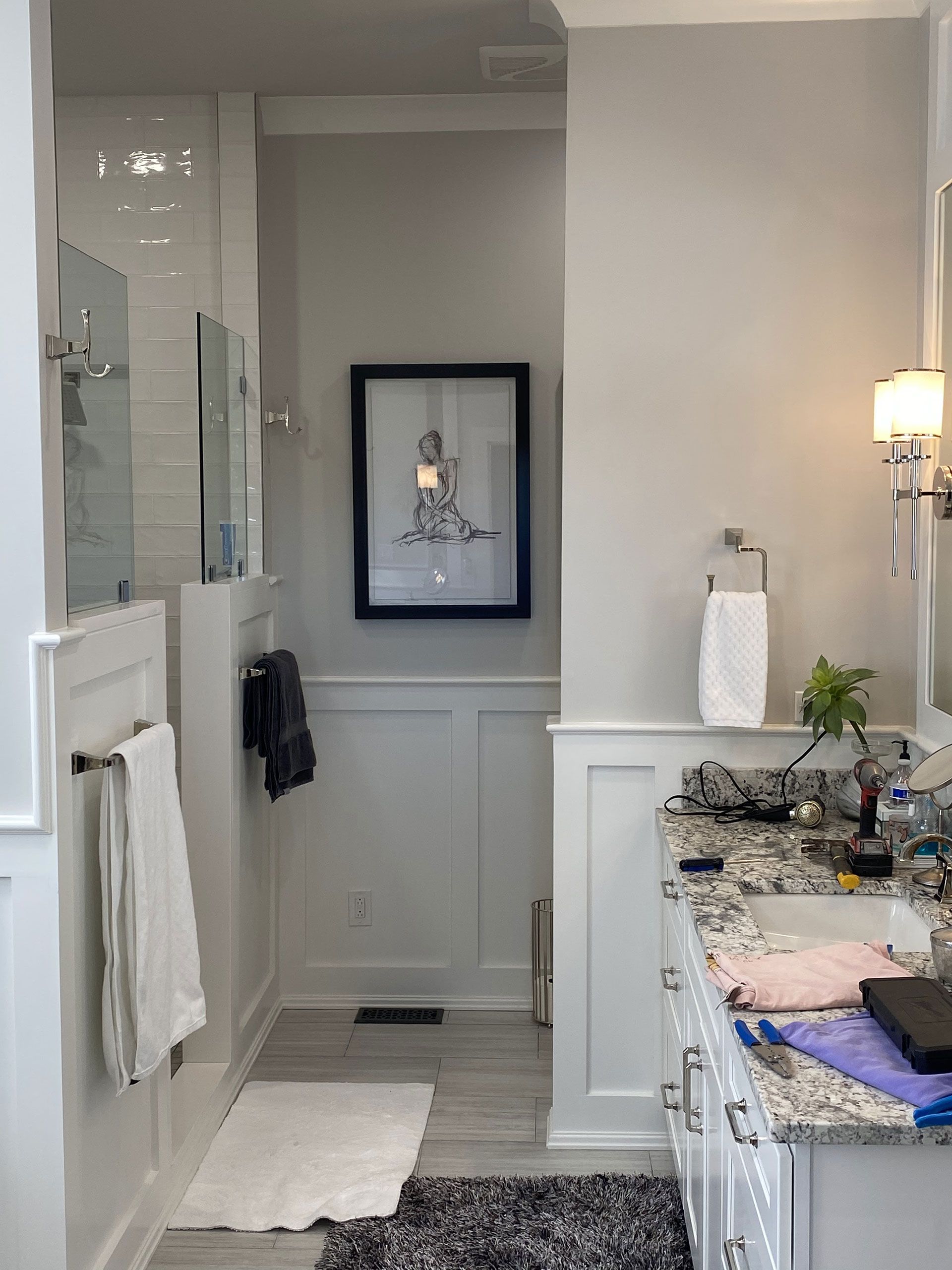 A bathroom with a sink, mirror, and shower