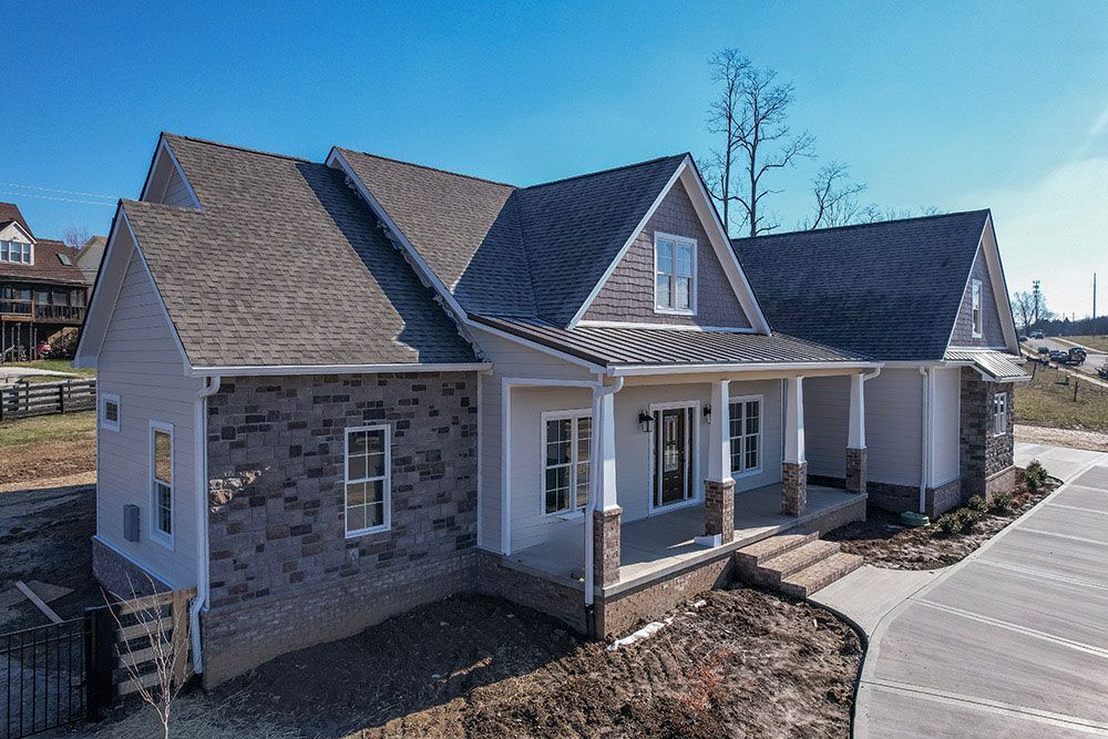 An aerial view of a house with a large porch.