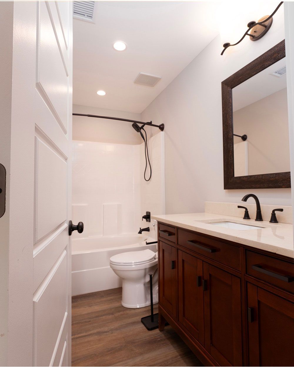 A bathroom with a toilet a sink and a mirror
