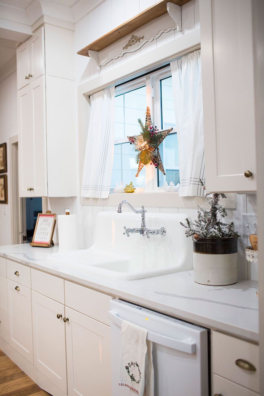 A kitchen with white cabinets