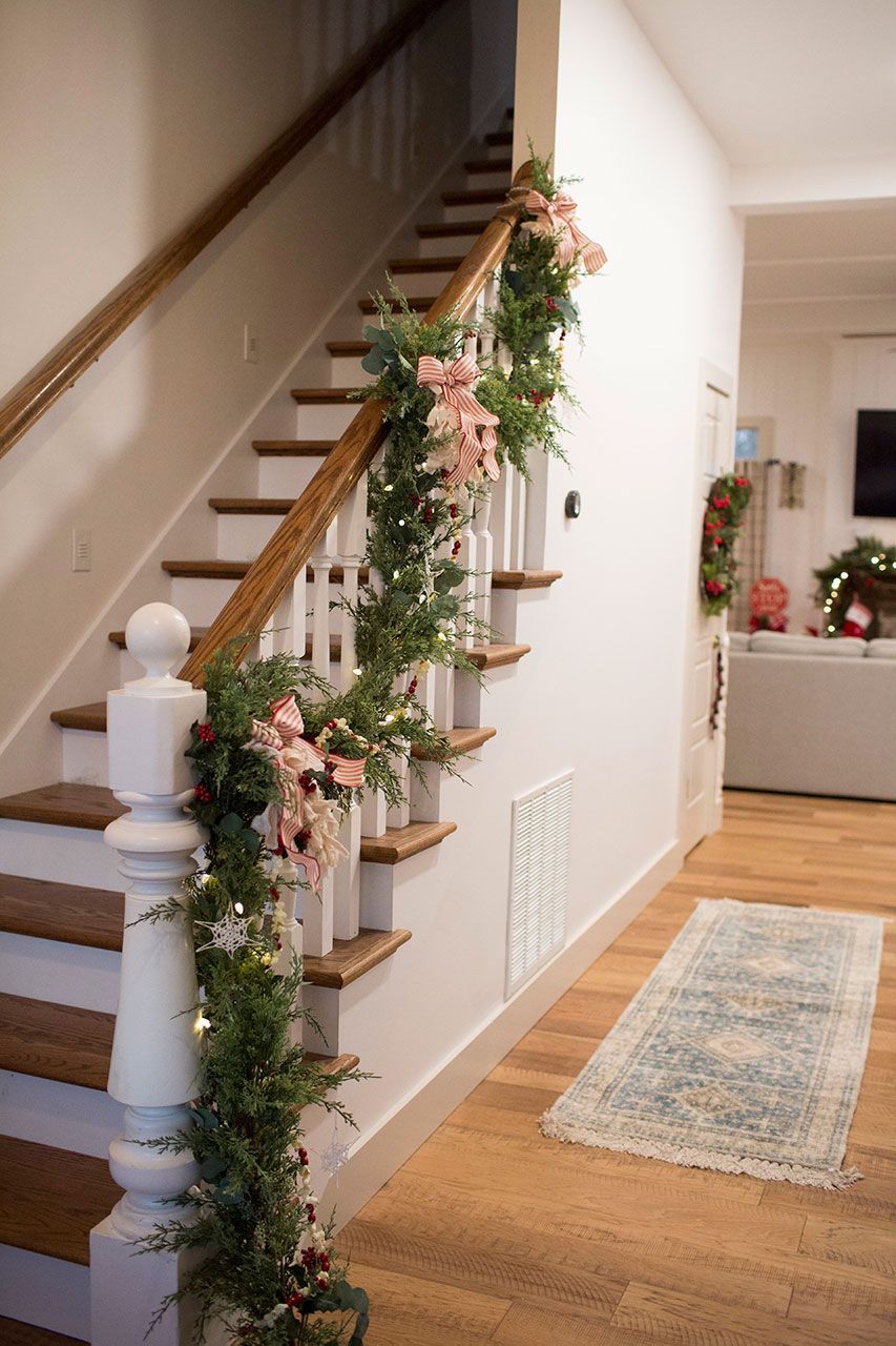 A staircase decorated with flowers and greenery in a hallway