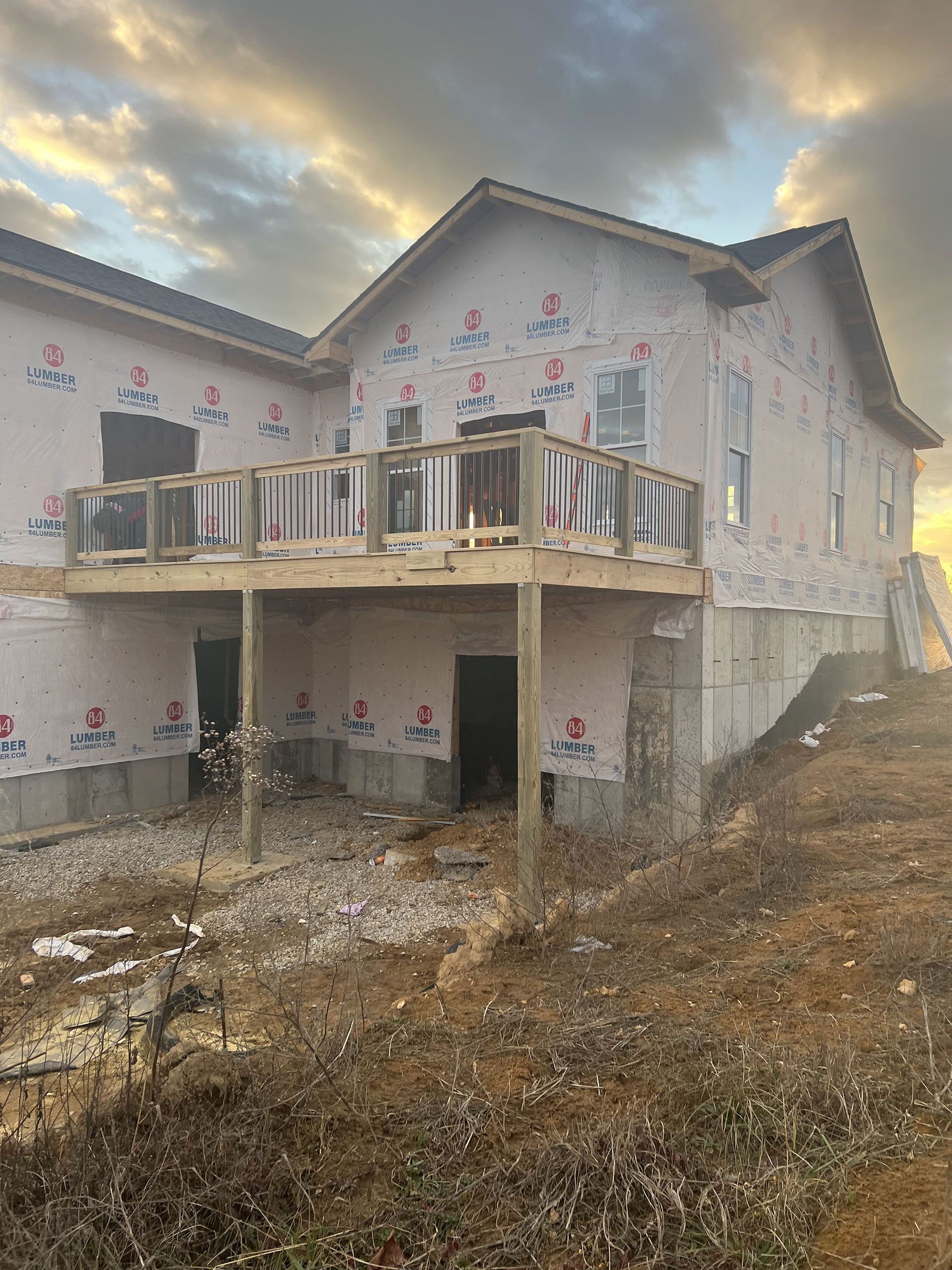 A large house under construction with a large deck