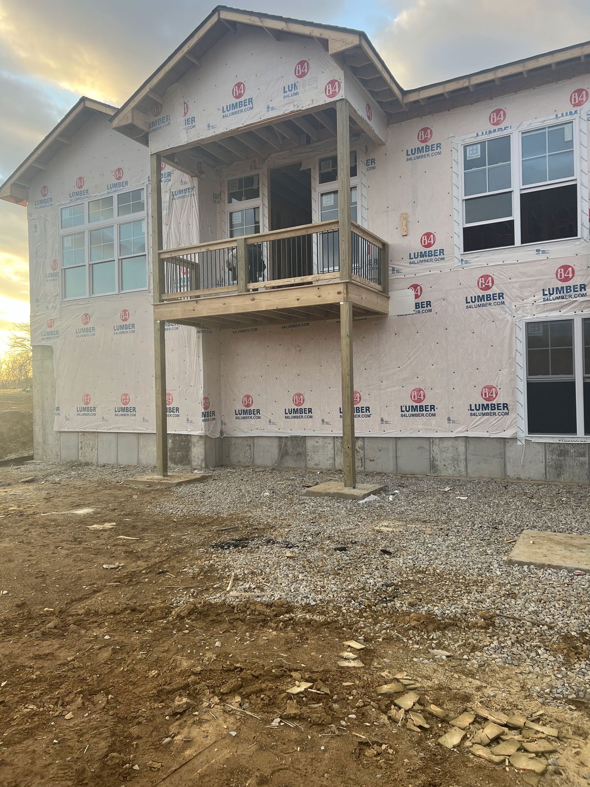 A large house is being built with a lot of windows and a balcony