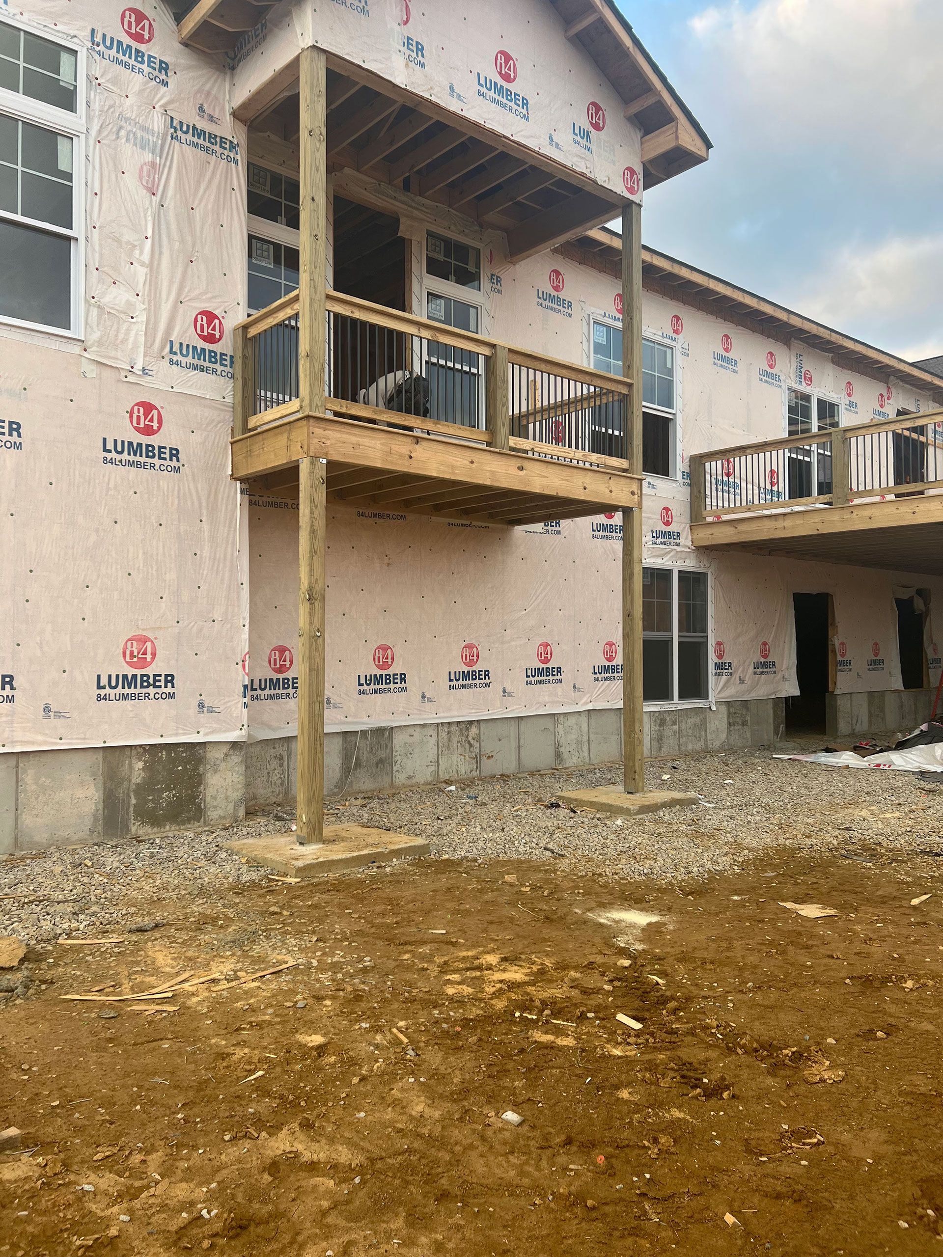 A house is being built with a lot of windows and a balcony