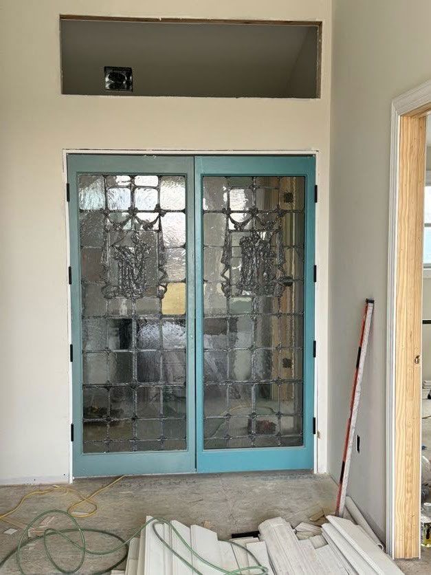 A pair of blue stained glass doors in a room