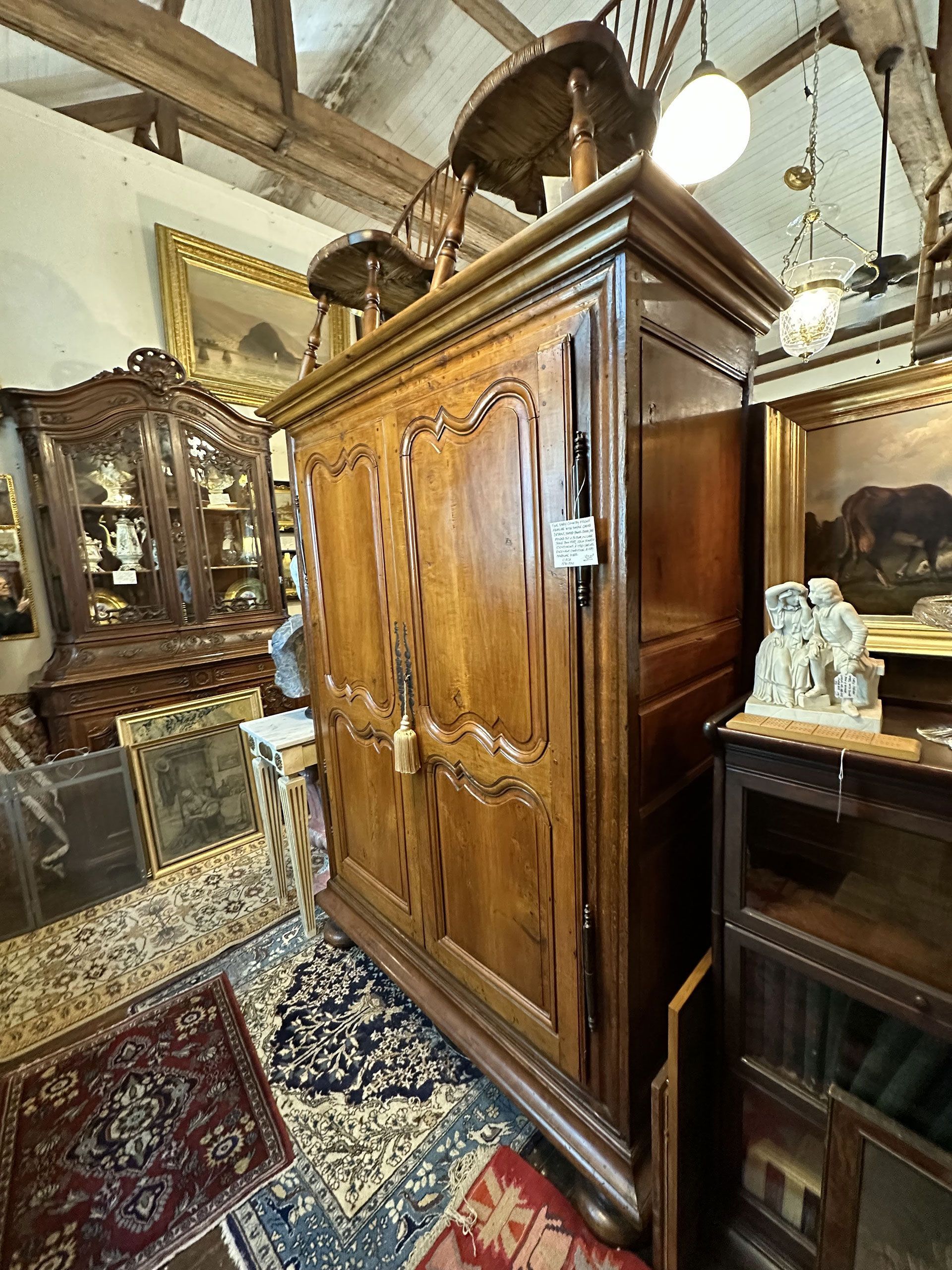 There is a large wooden cabinet in the middle of the room.