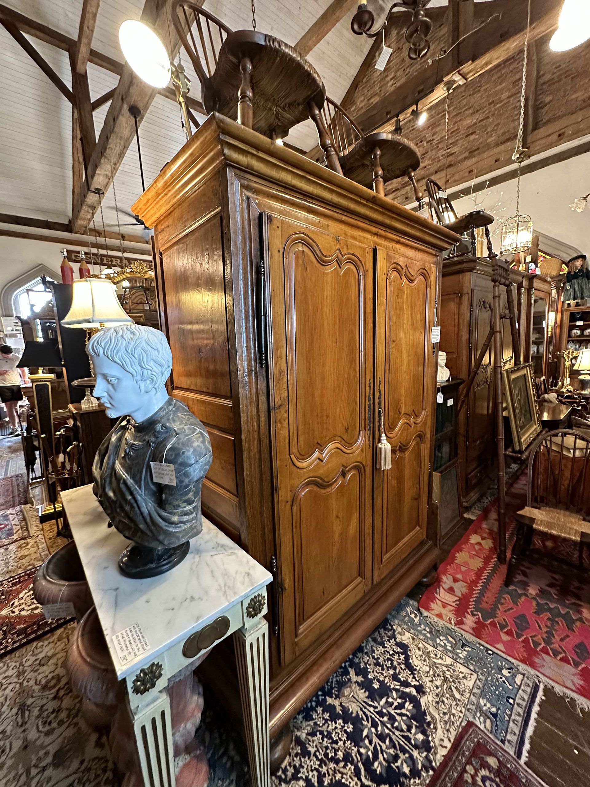 There is a large wooden cabinet in the middle of the room.