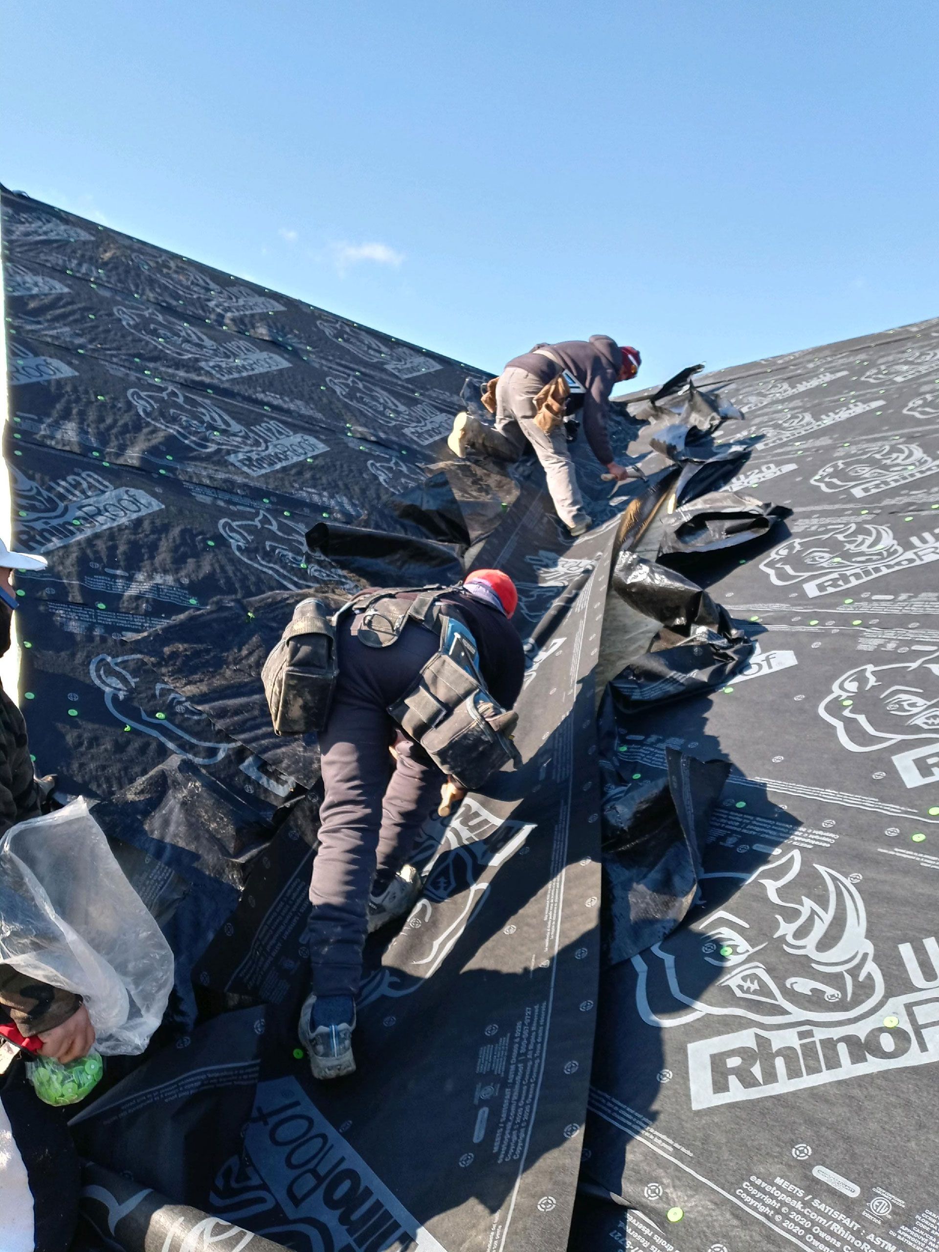 A group of people are working on a roof