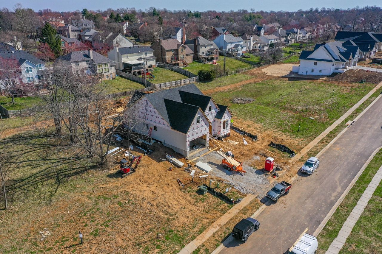 An aerial view of a house under construction in a residential neighborhood.