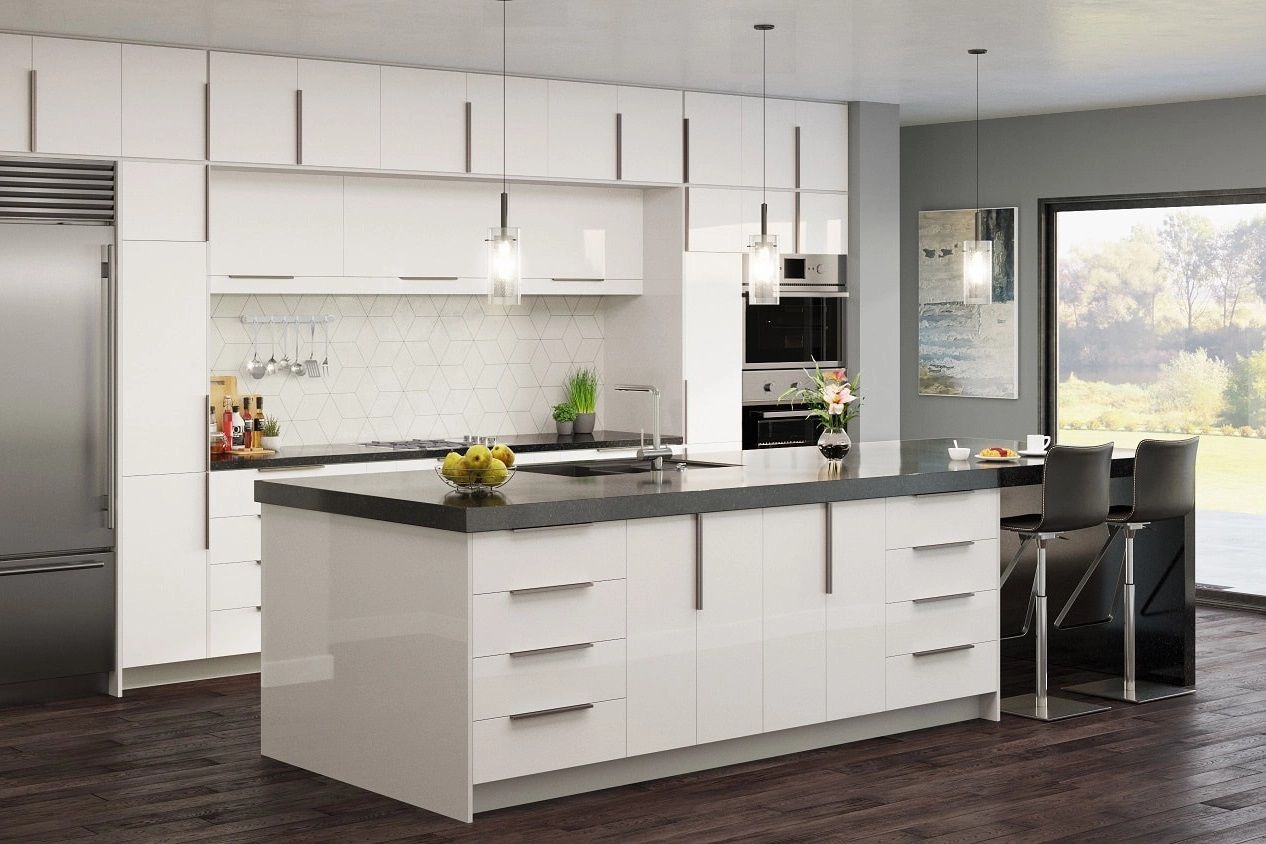 Modern white kitchen with island, pendant lights, stainless appliances, and dark flooring