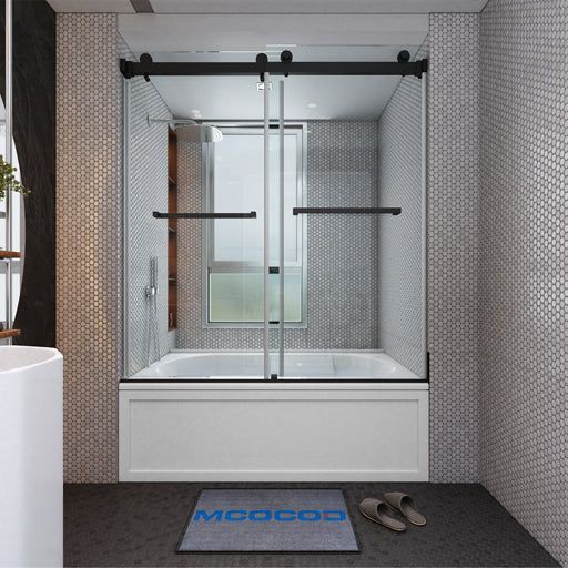 Modern bathroom with a glass shower enclosure, blue bath mat, and slippers on a dark floor.