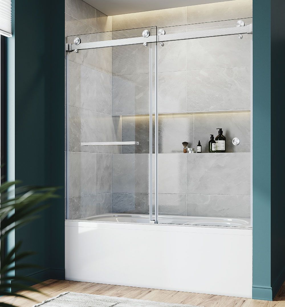 Modern walk-in shower with glass doors, light stone tiles, and white tub base