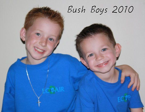 Two smiling boys in blue shirts posing together with an arm around each other, labeled “Bush Boys 2010”