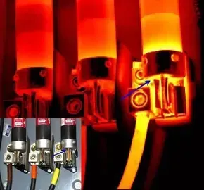 Thermal image of electrical connections, showing overheating. Bright orange/yellow indicates excessive heat at terminals.