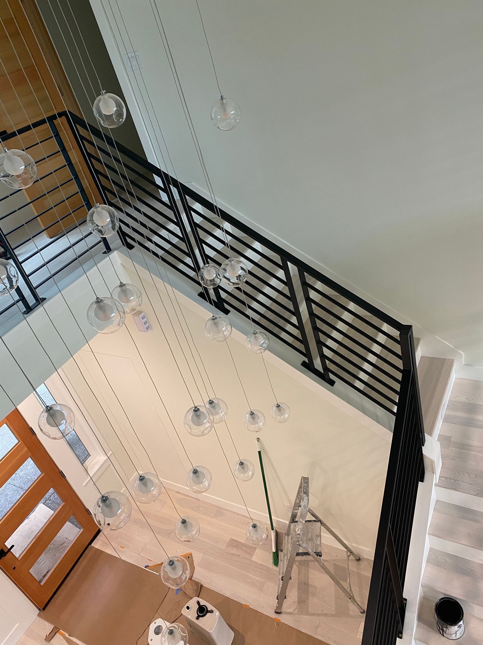 An aerial view of a living room with stairs and a railing