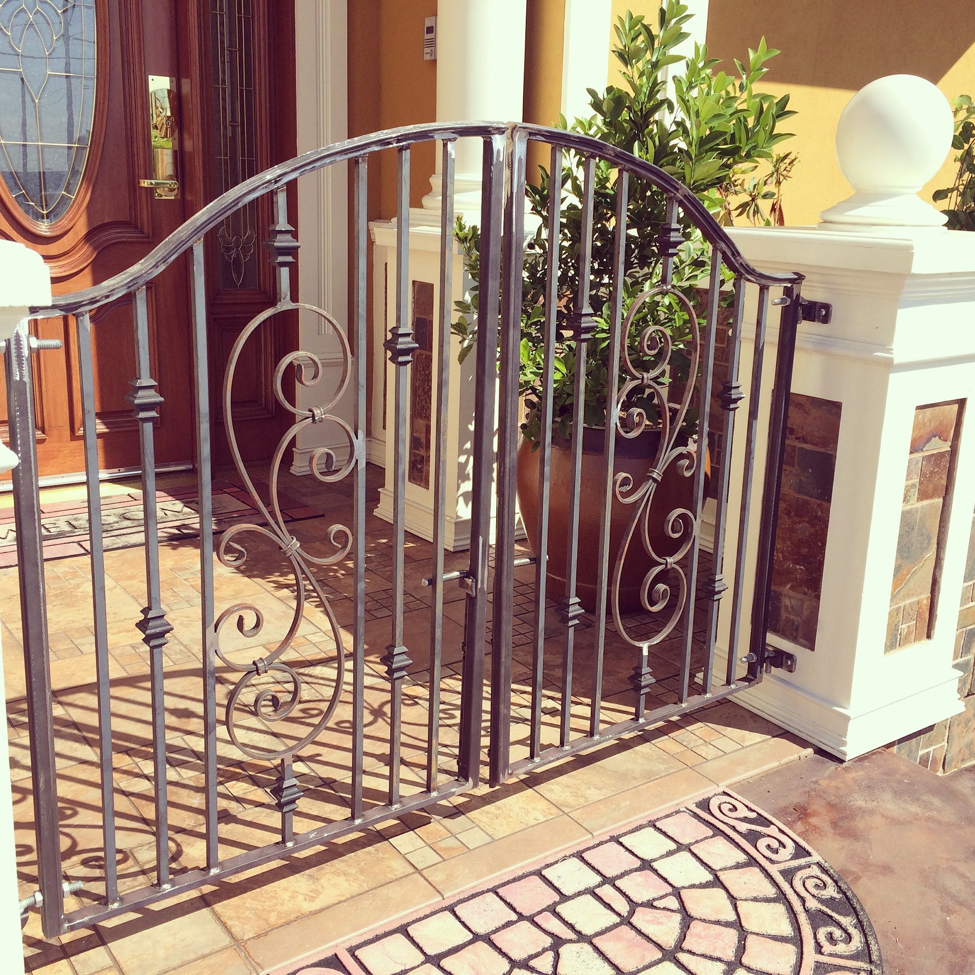A wrought iron gate in front of a house