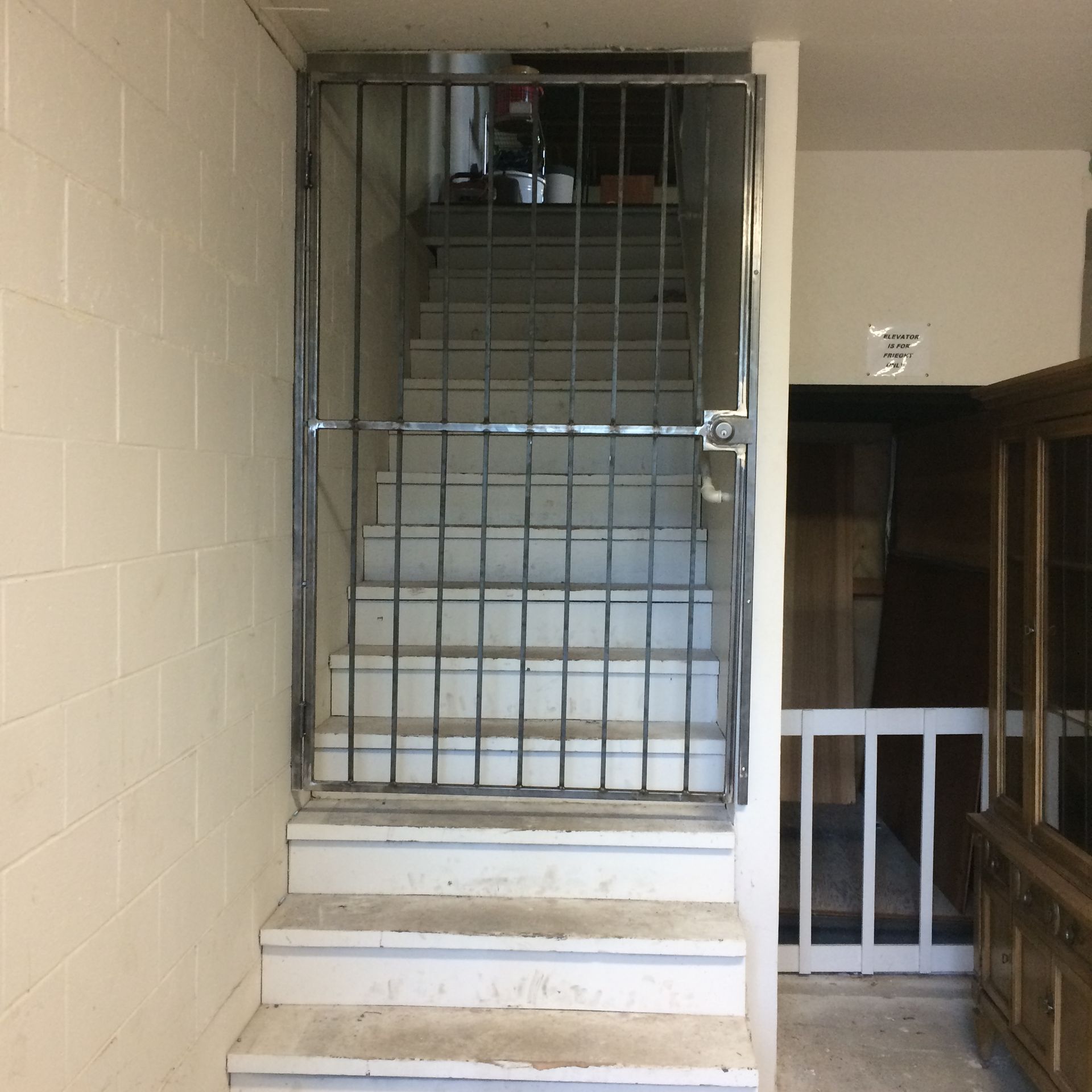 A set of stairs with a metal gate between them