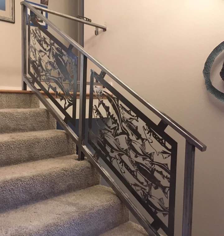 A staircase with a metal railing and a carpeted floor