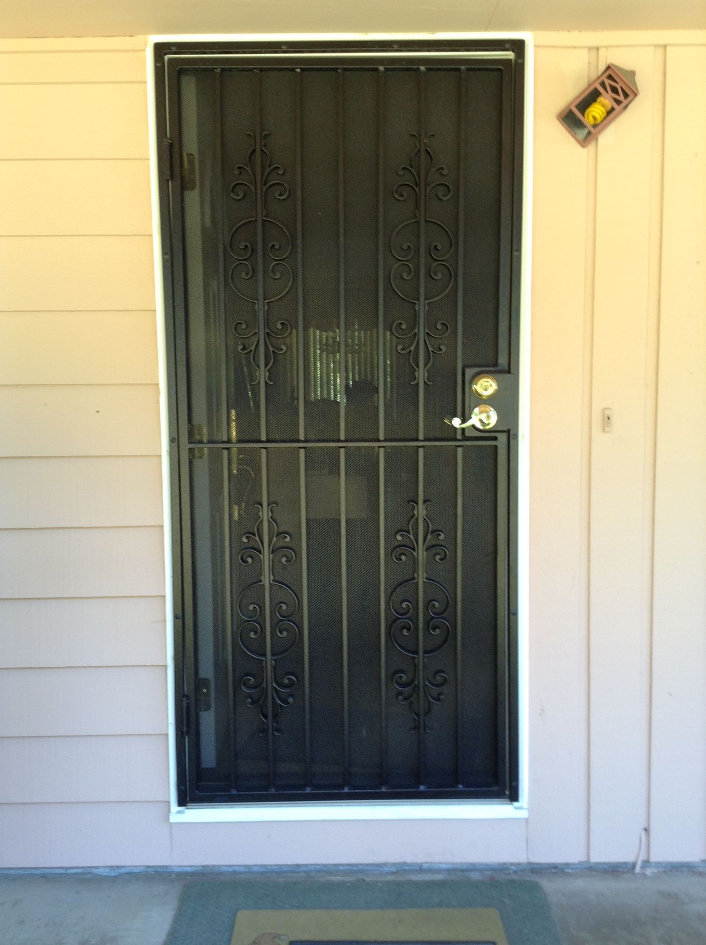 The front door of a house with a wrought iron