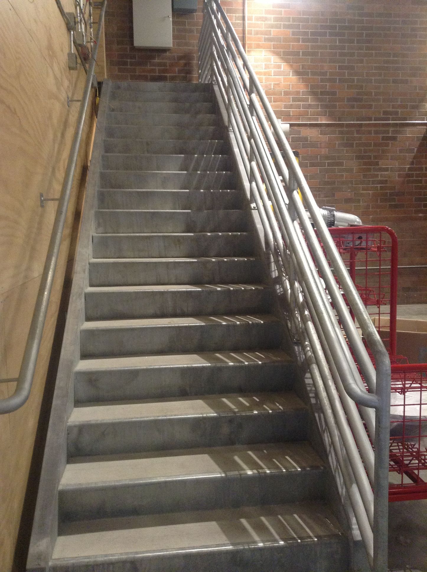 A staircase in a building with pipe railing