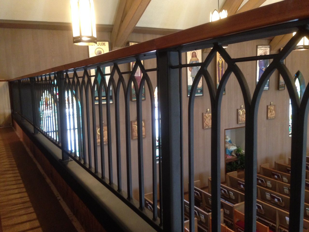 A view of a church from a balcony with a wrought iron railing