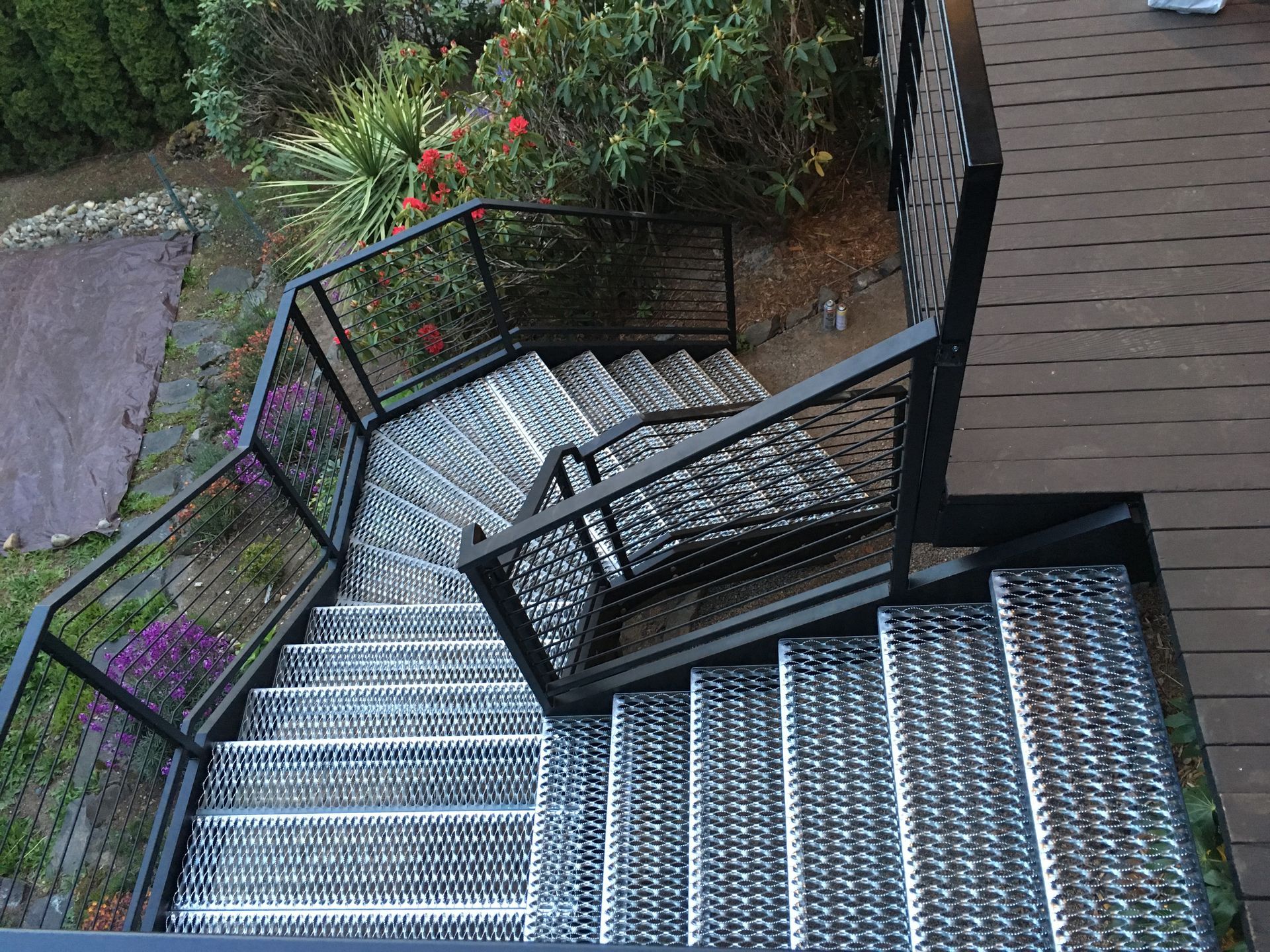 A set of metal stairs leading up to a wooden deck
