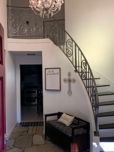 A staircase with a sign on the wall that says to be remembered