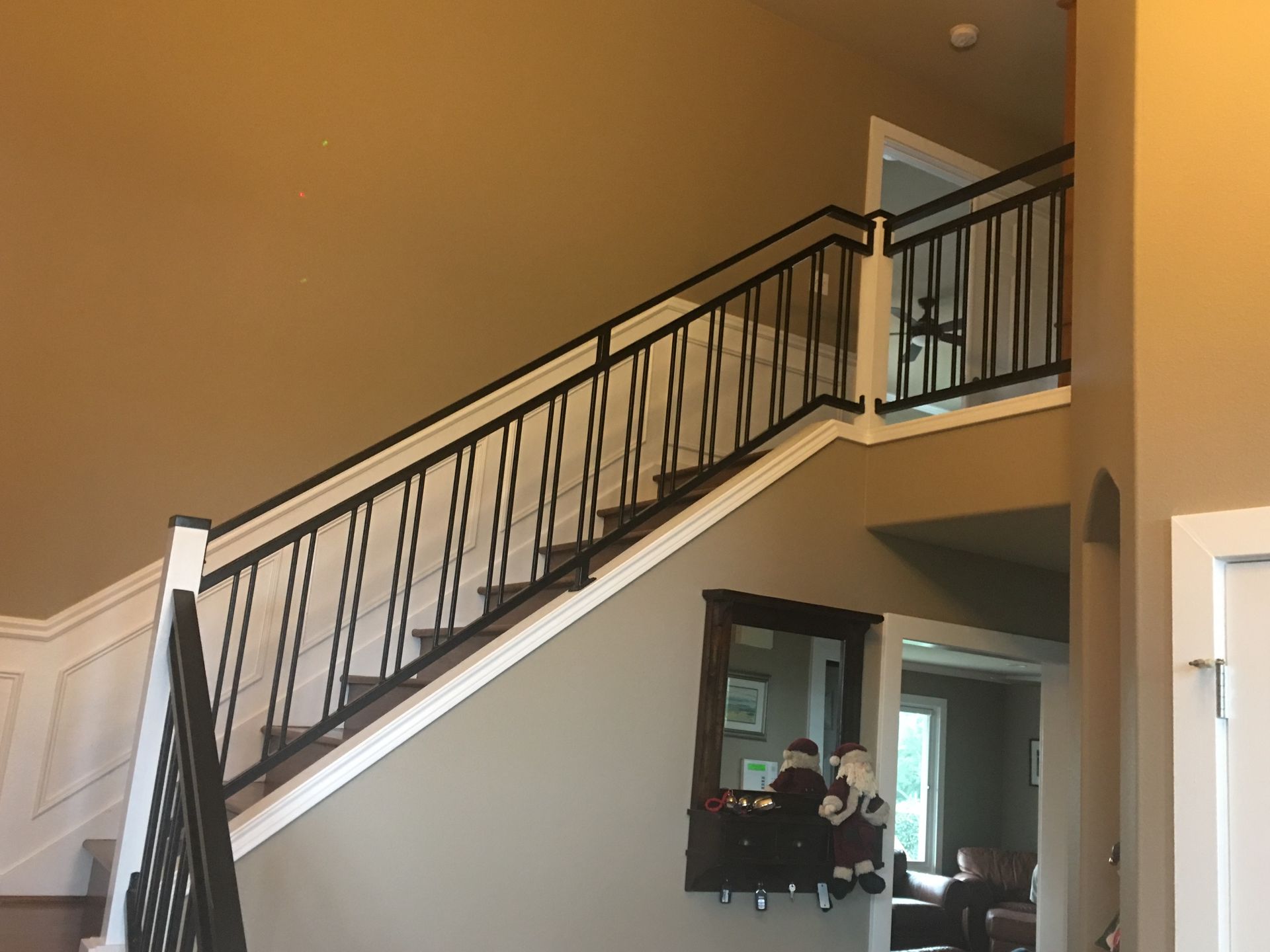 A staircase in a house with a black railing